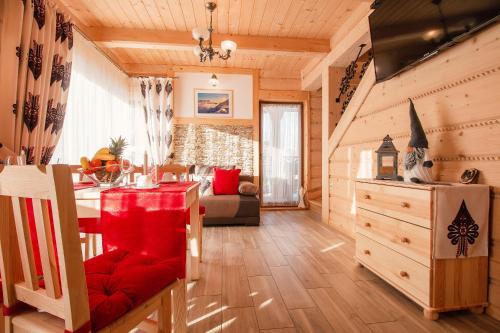 a living room with a dining table and a living room at Domki Pod Jemiołą in Zakopane