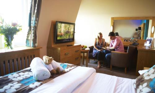 a couple of people sitting in a hotel room at Crown Spa Hotel Scarborough by Compass Hospitality in Scarborough