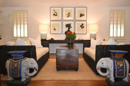 a living room with two couches and a table at Rachamankha Hotel in Chiang Mai