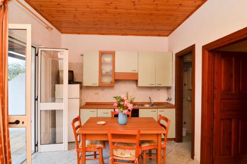a kitchen with a table with a vase of flowers on it at Residence Limoneto Ischia in Ischia