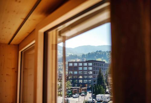 a window with a view of a city at Hotel Krone in Dornbirn