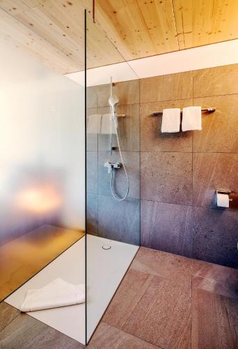 a bathroom with a shower with a glass door at Hotel Krone in Dornbirn