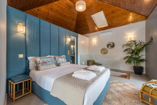 a bedroom with a large bed with blue walls at Victoria Project - Houses - Private Parking in Porto