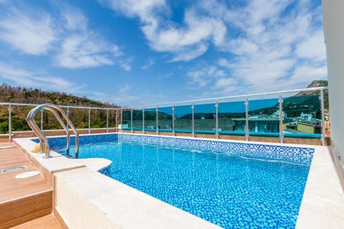 a swimming pool with a view of a building at Villa Jadranka Sutomore in Sutomore