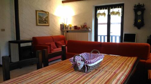 a living room with a table and a couch at La Segheria in Pragelato