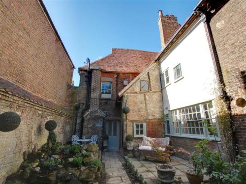 an old brick house with a patio in front of it at Holiday Home Strand Street by Interhome in Sandwich