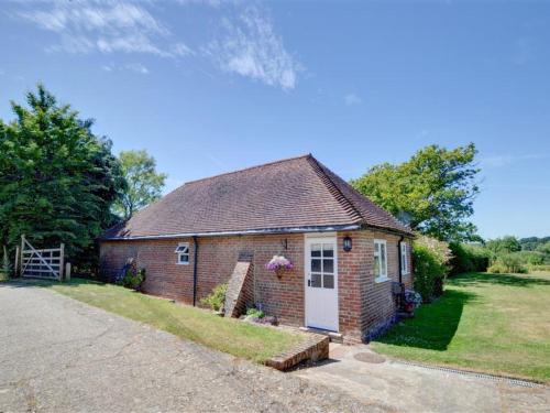 a small brick house with a white door at Holiday Home Baley by Interhome in Goudhurst
