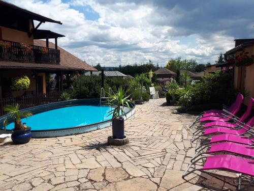 eine Terrasse mit Stühlen und einem Pool in der Unterkunft Areál Pauli in Česká Skalice