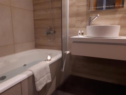 a bathroom with a bath tub and a sink at Portal del Callvú in Azul