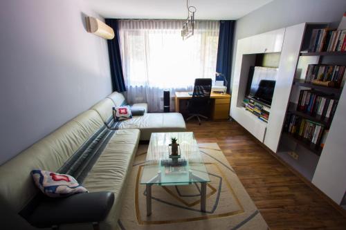 a living room with a couch and a coffee table at Modern Apartment in the Heart of Vidin in Vidin