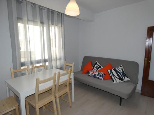 a living room with a couch and a table at APARTAMENTOS DAYMA in Jarandilla de la Vera