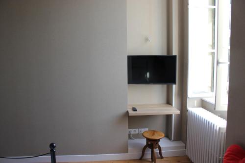 a living room with a flat screen tv on a wall at CLOS MARIE in Iguerande