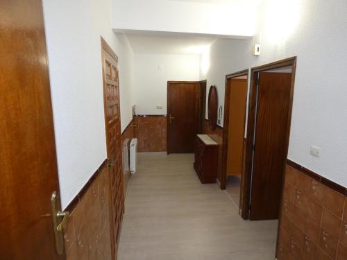 a hallway with wooden doors and a hallway with a hallway at APARTAMENTOS DAYMA in Jarandilla de la Vera