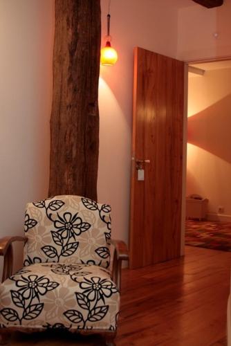a chair with a pillow sitting next to a tree at Goiko-Benta Ostatua in Oñate