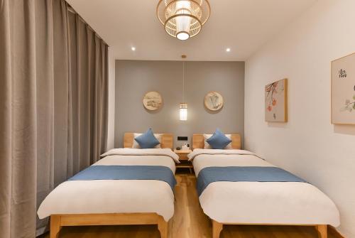 Ένα ή περισσότερα κρεβάτια σε δωμάτιο στο Yifangyan - Tingyuan Qingshe Hostel