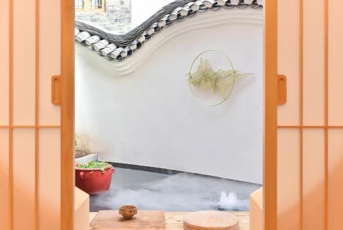a view of a patio through a door at Yifangyan - Tingyuan Qingshe Hostel in Fenghuang