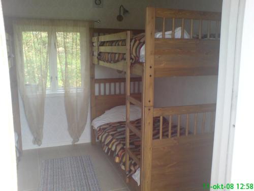 a bedroom with bunk beds in a room with a window at Grindhammaren B&B in Ramsberg