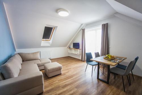 a living room with a couch and a table at Berill Suites in Sárvár
