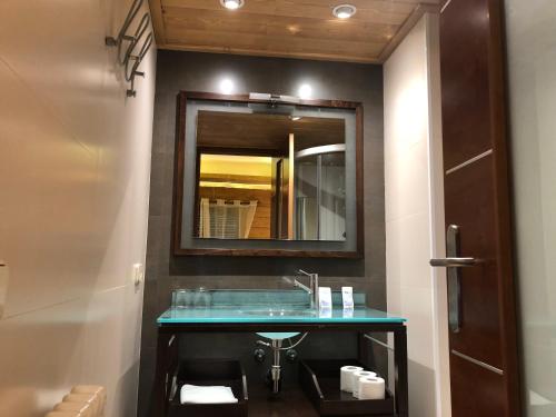 a bathroom with a sink and a mirror at Hostal Piteus in Sant Llorenc de Morunys