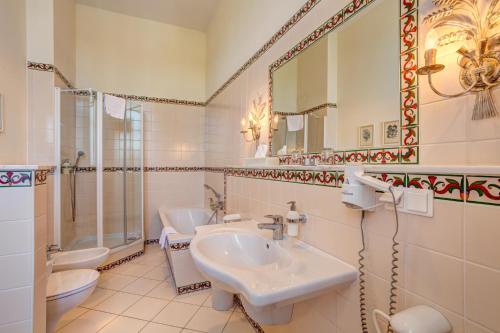 a bathroom with a sink and a toilet and a mirror at Schloss Lübbenau in Lübbenau