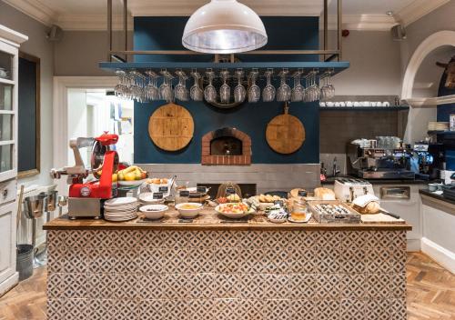 a kitchen with a counter with food on it at The Painswick in Painswick