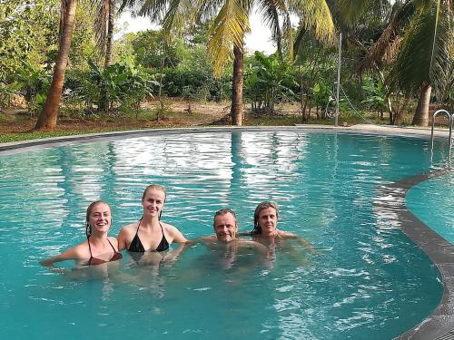 a group of people in a swimming pool at The Nature Park Villa in Sigiriya