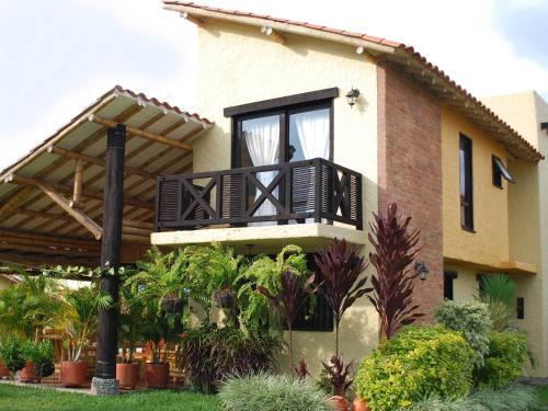 a house with a balcony with a window at Decameron Panaca - All Inclusive in Quimbaya
