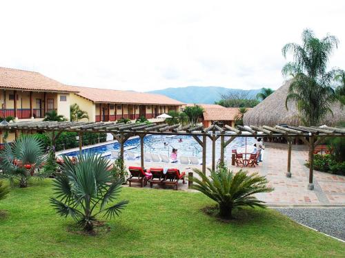 a resort with a pool and a table and chairs at Decameron Panaca - All Inclusive in Quimbaya
