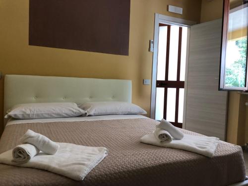 a bedroom with two towels on a bed at Casa Vacanze Nonna Suocera in San Severino