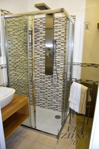 a shower with a glass door in a bathroom at Via Ziino 70 in Oliveri