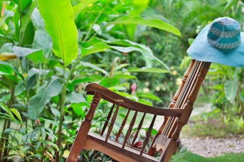 a hat sitting on top of a wooden chair at Zula Inn Aparthotel in Santa Teresa Beach