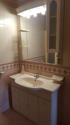 a bathroom with a sink and a large mirror at Your Dream Our Passion in Nazaré