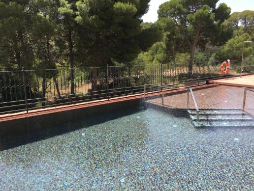 a pool of water next to a metal fence at Jardines de La Santa in Totana