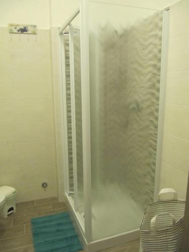 a shower with a glass door in a bathroom at Station Home in Sesto San Giovanni