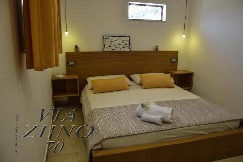 a bedroom with a bed with two towels on it at Via Ziino 70 in Oliveri