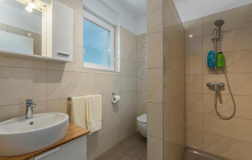 a bathroom with a sink and a toilet and a shower at Apartment Complex Jelena in Funtana