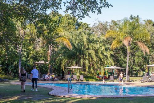 a group of people walking around a swimming pool at Kruger Park Lodge Unit No. 611 in Hazyview