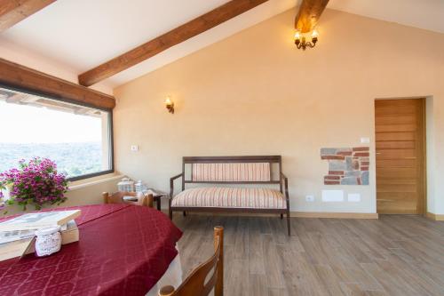 a bedroom with a bed and a table and a window at Ca Montiglio in Quagliuzzo