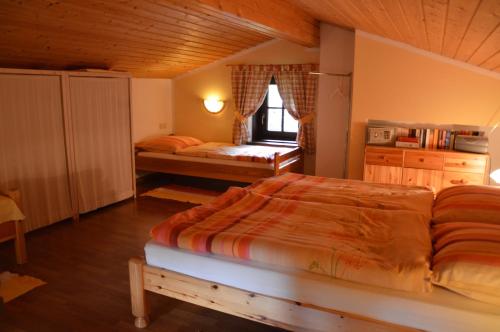 a bedroom with a large bed and a window at Alte Schmiede in Bad Gastein