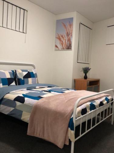 a bedroom with a bed with blue and white at Modern Apartment in Liverpool CBD in Liverpool