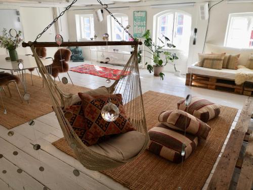 a hammock with pillows in a living room at A Charming and Beautiful Oasis in the Heart of Copenhagen in Copenhagen