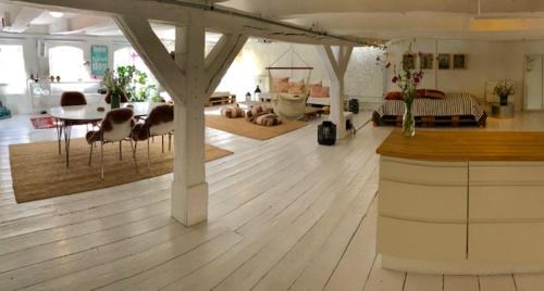 a large living room with a table and chairs in a room at A Charming and Beautiful Oasis in the Heart of Copenhagen in Copenhagen