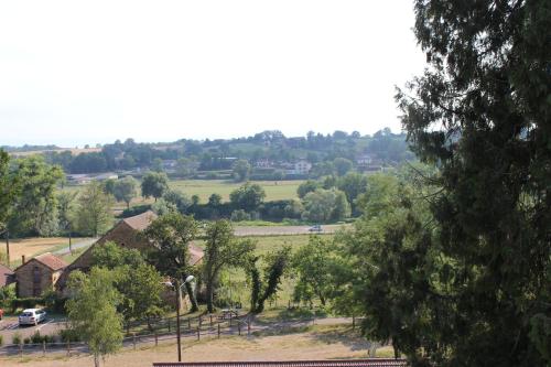 a view of a house with trees and a field at CLOS MARIE in Iguerande