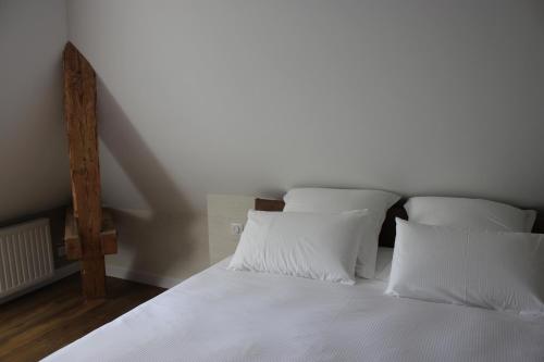 a white bed with white sheets and pillows at CLOS MARIE in Iguerande