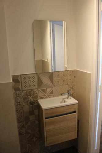 a bathroom with a sink and a mirror at CLOS MARIE in Iguerande