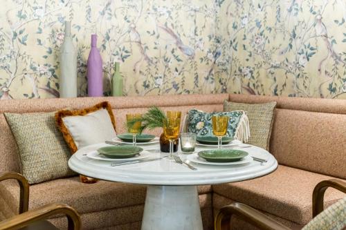 a table with plates and glasses on top of a couch at Hotel Capital in Zagreb