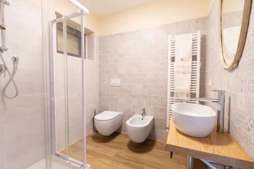 a bathroom with a toilet and a sink and a shower at Ca Montiglio in Quagliuzzo