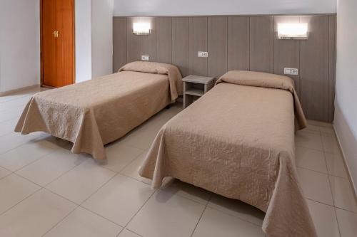 Кровать или кровати в номере Hotel Niza