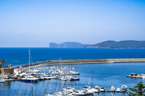 a marina filled with lots of boats on a cloudy day at Hotel Catalunya in Alghero