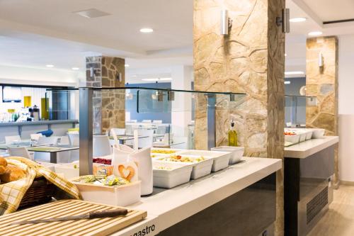 a buffet in a restaurant with food on display at Hotel Mimosa in Sidari